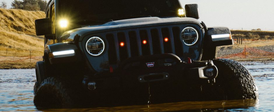 jeep being driven in a body of water